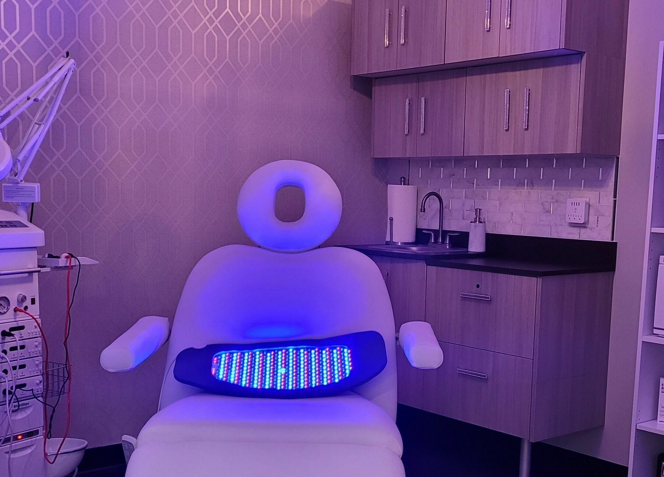 Modern treatment room at Village Skin Sanctuary, Audubon, Pennsylvania, US with sleek equipment and ambient lighting.