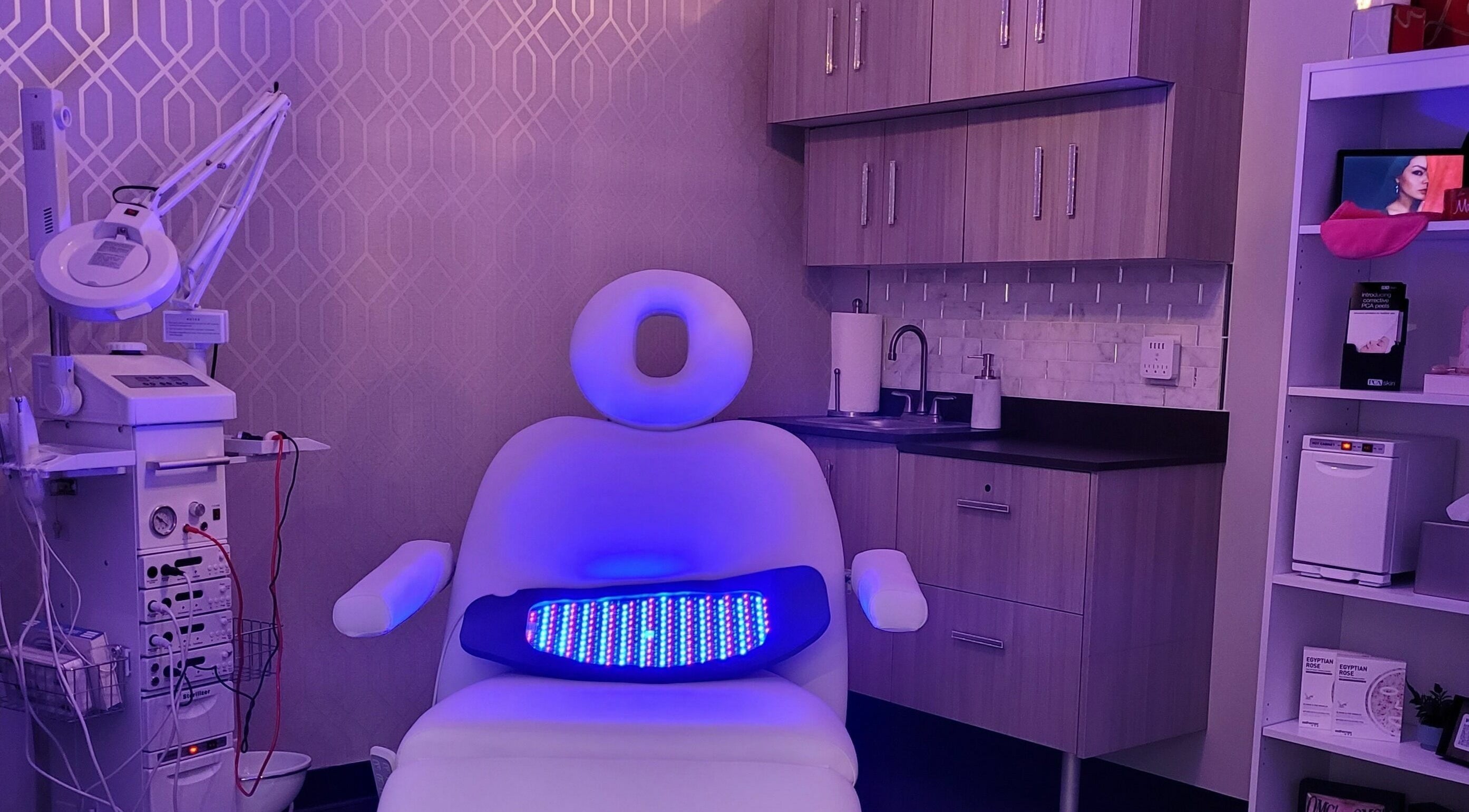 Modern treatment room at Village Skin Sanctuary, Audubon, Pennsylvania, US with sleek equipment and ambient lighting.