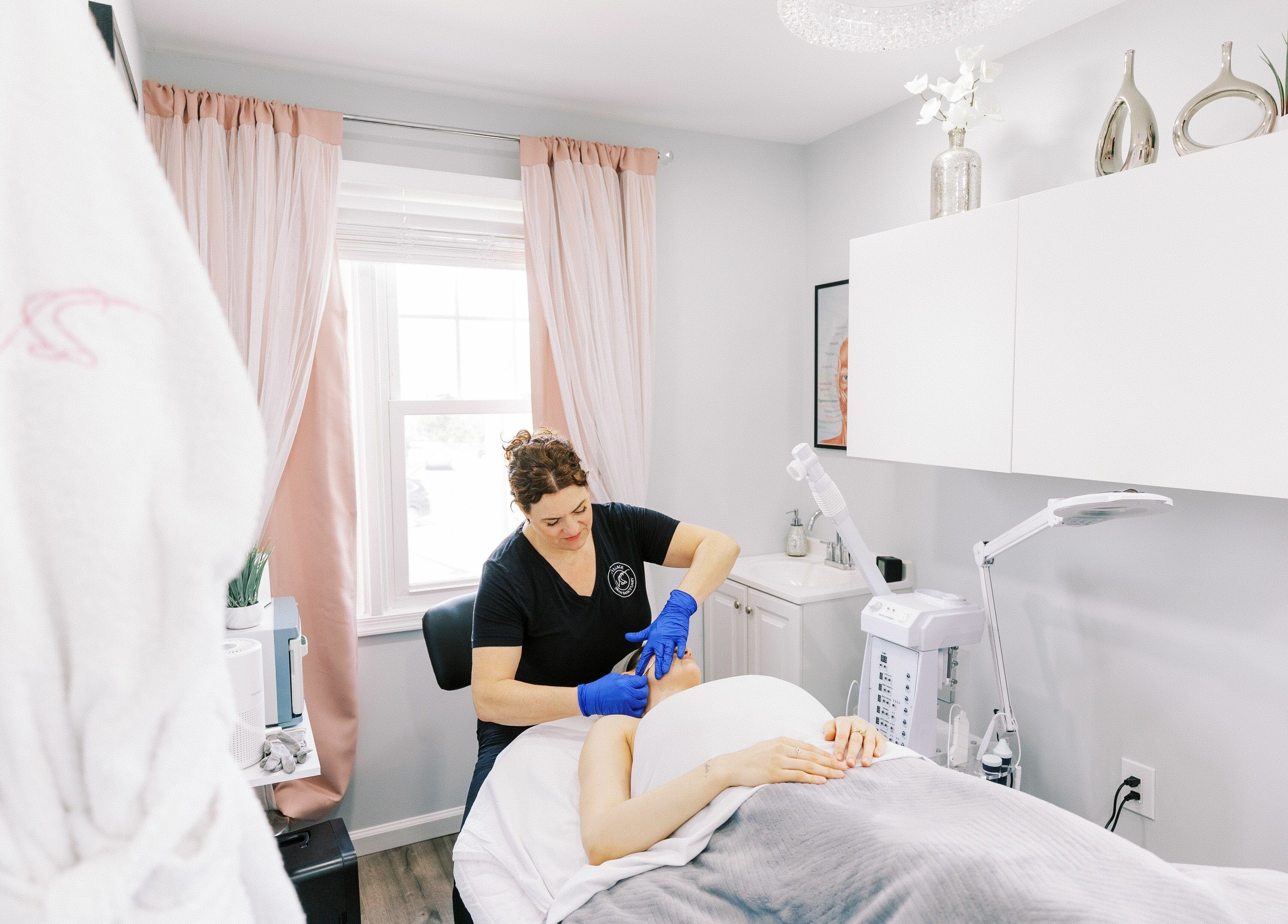 Aesthetician performing facial treatment at Village Skin Sanctuary, Audubon, Pennsylvania, US.