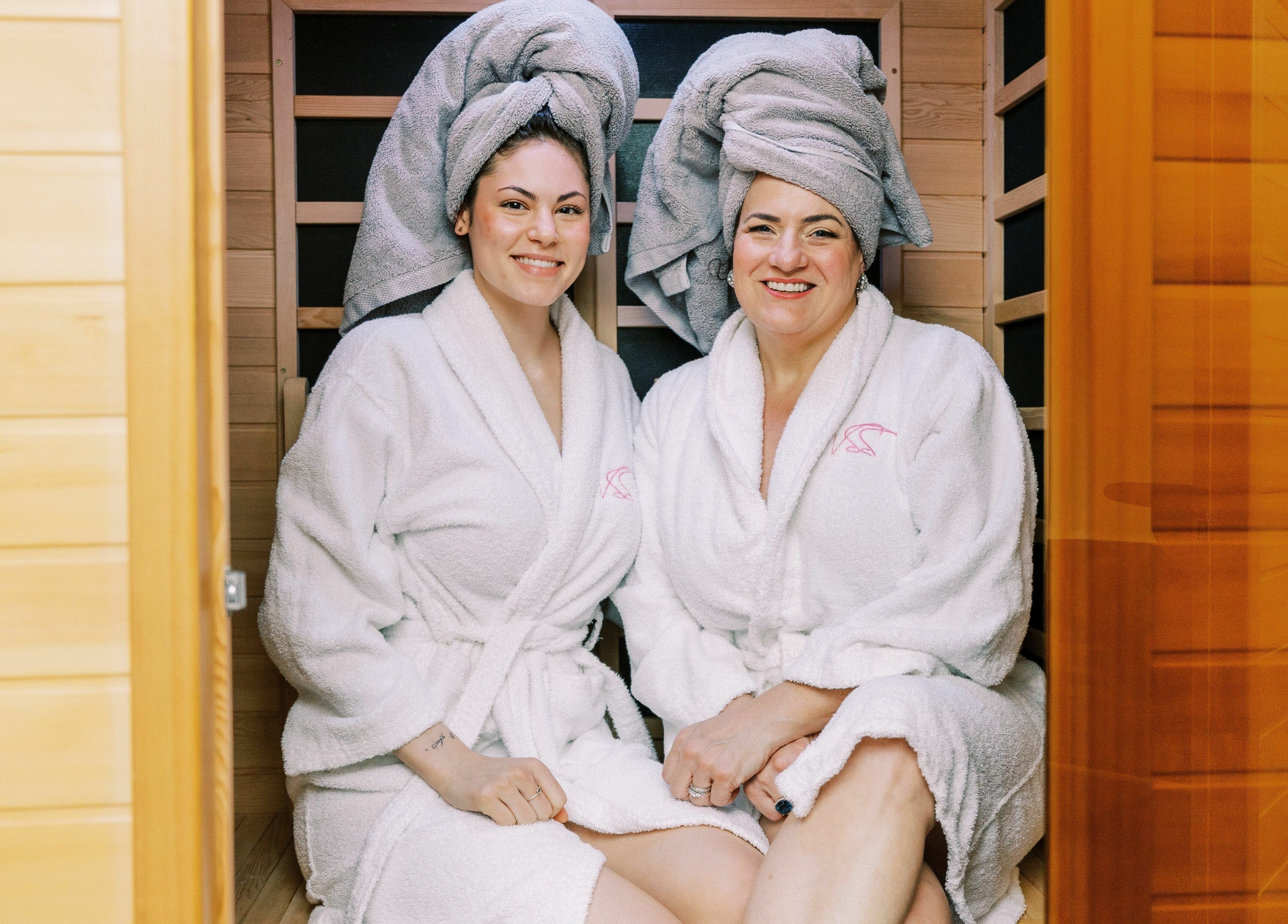 Two women in robes enjoy a sauna at Village Skin Sanctuary in Audubon, Pennsylvania, US.