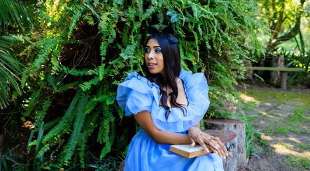 Woman in blue dress sitting amidst greenery at Black Cat Collective, Port Elizabeth, Eastern Cape, ZA.