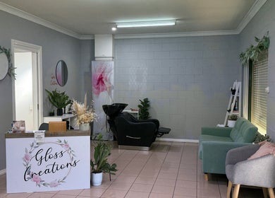 Gloss Creations salon in Wallerawang, NSW, AU showcases a cozy reception and stylish seating area.