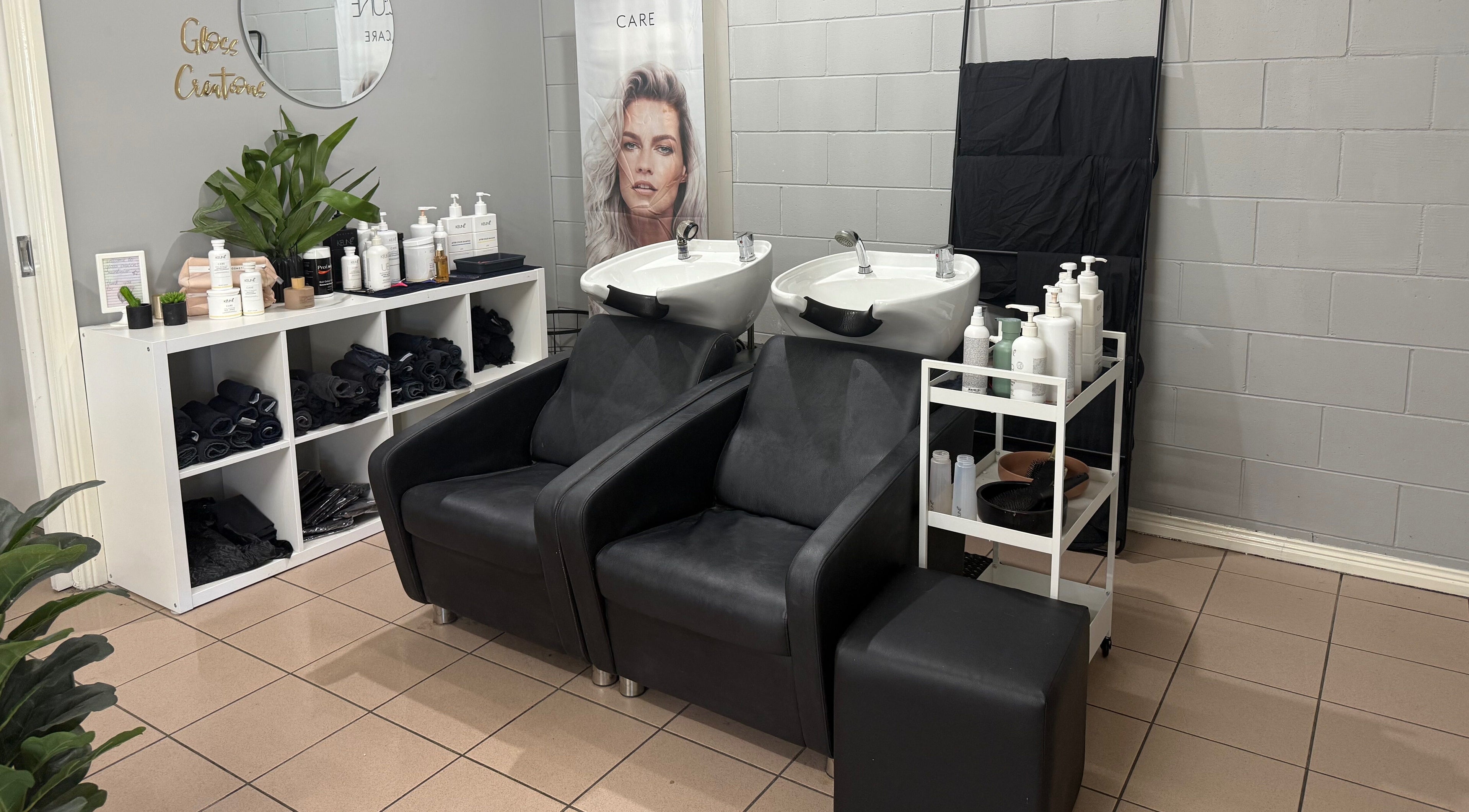 Gloss Creations hair washing station featuring sleek chairs and product display in Wallerawang, NSW, AU.
