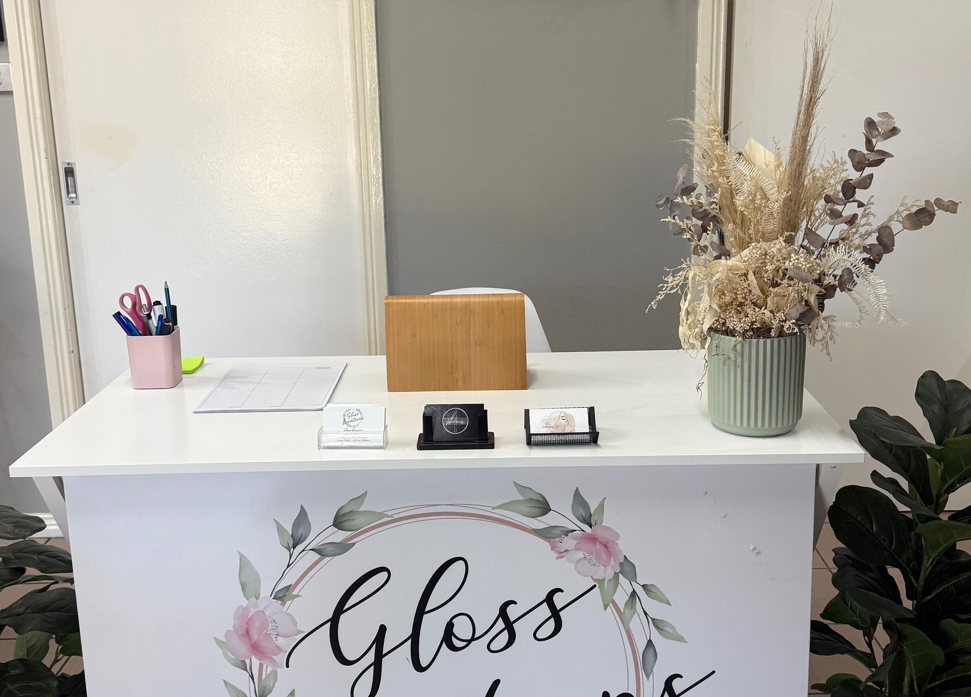 Gloss Creations reception desk with floral decor in Wallerawang, NSW, AU welcoming guests.