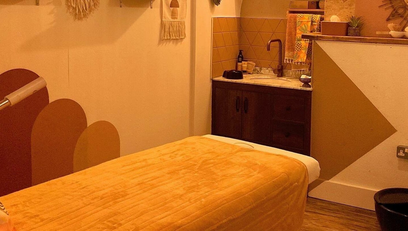 Cozy massage room at Boho Beauty, Braunton, England, GB with warm tones and a tranquil atmosphere.