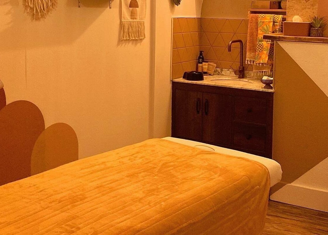 Cozy massage room at Boho Beauty, Braunton, England, GB with warm tones and a tranquil atmosphere.