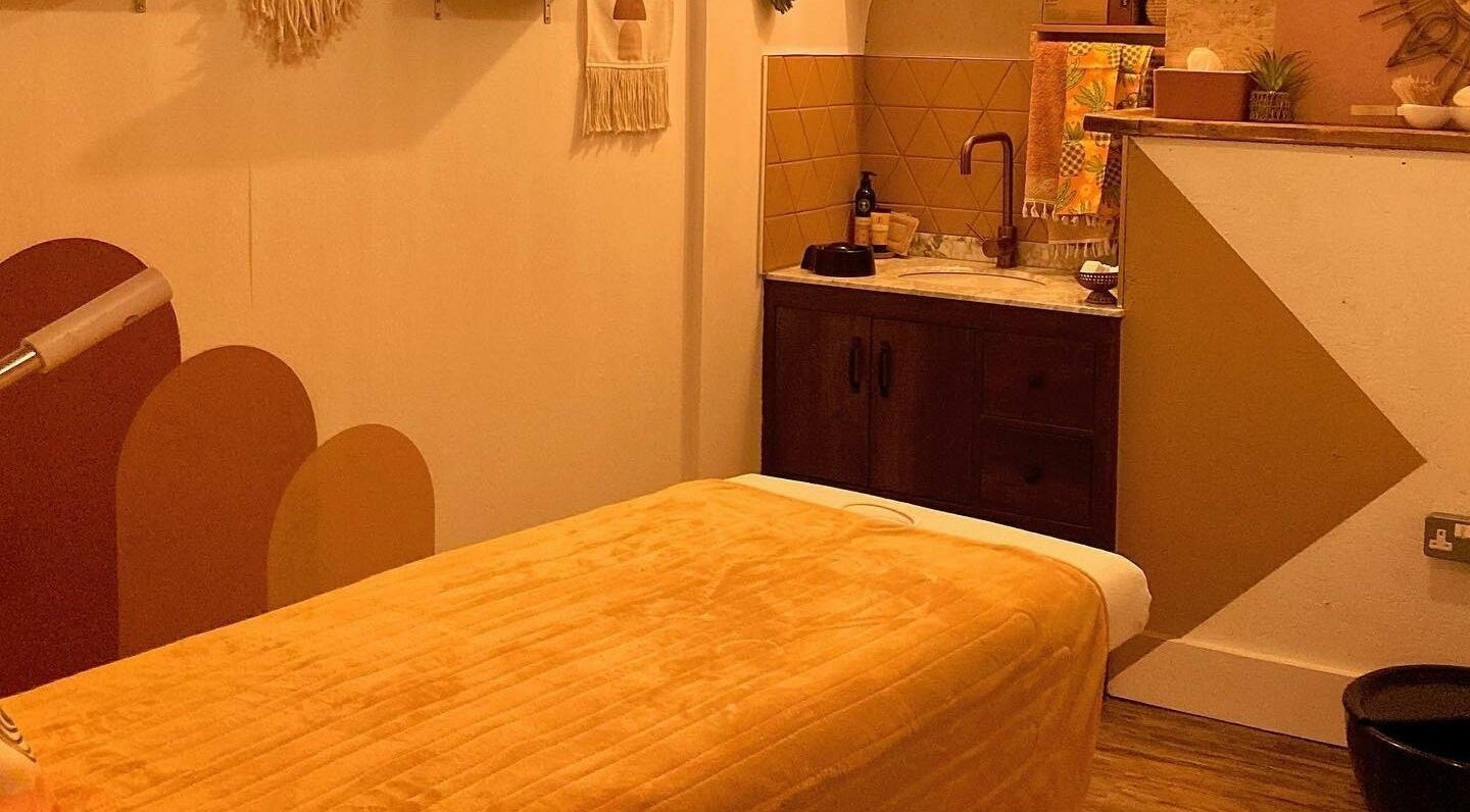 Cozy massage room at Boho Beauty, Braunton, England, GB with warm tones and a tranquil atmosphere.