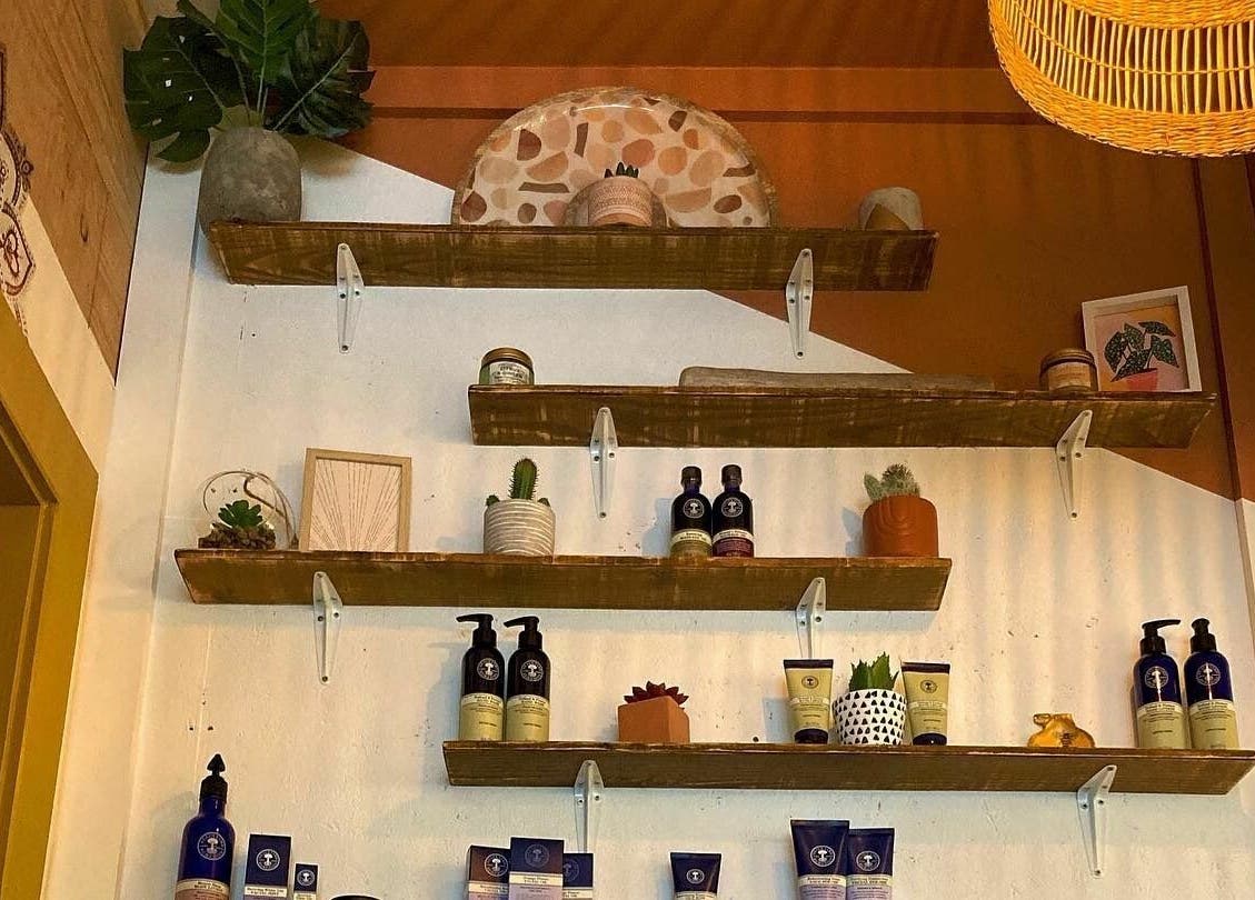 Stylish wooden shelves with beauty products at Boho Beauty, Braunton, England, GB.