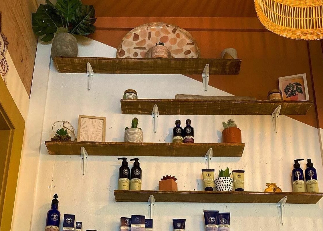 Stylish wooden shelves with beauty products at Boho Beauty, Braunton, England, GB.
