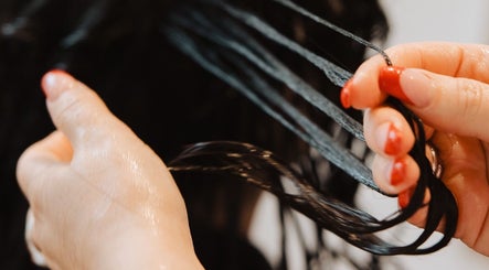 Close-up of a stylist applying treatment at Naomi Bolt in Kelowna, British Columbia, CA.