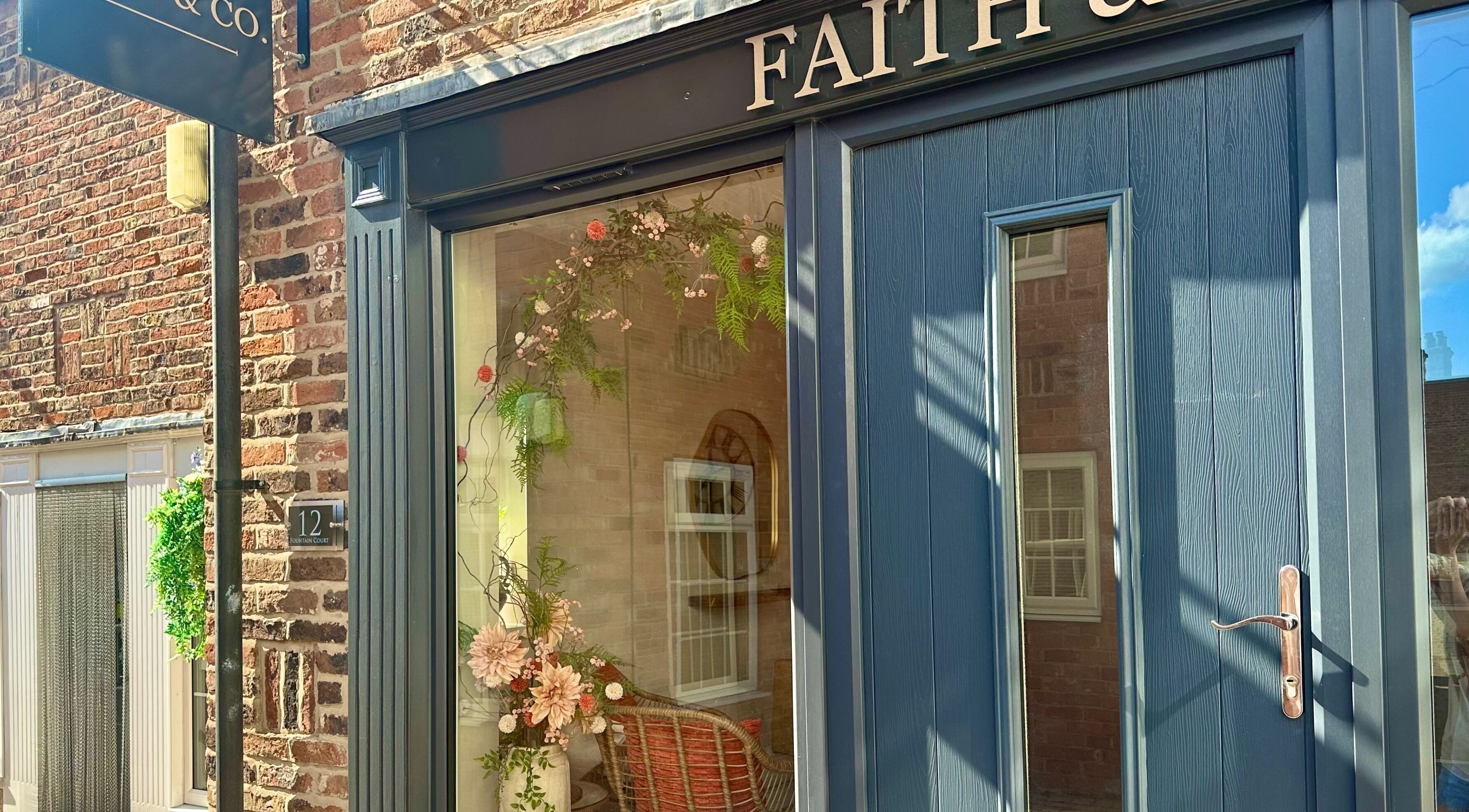 Entrance of Faith & Co. with floral decor at 12 Epworth, England, GB.