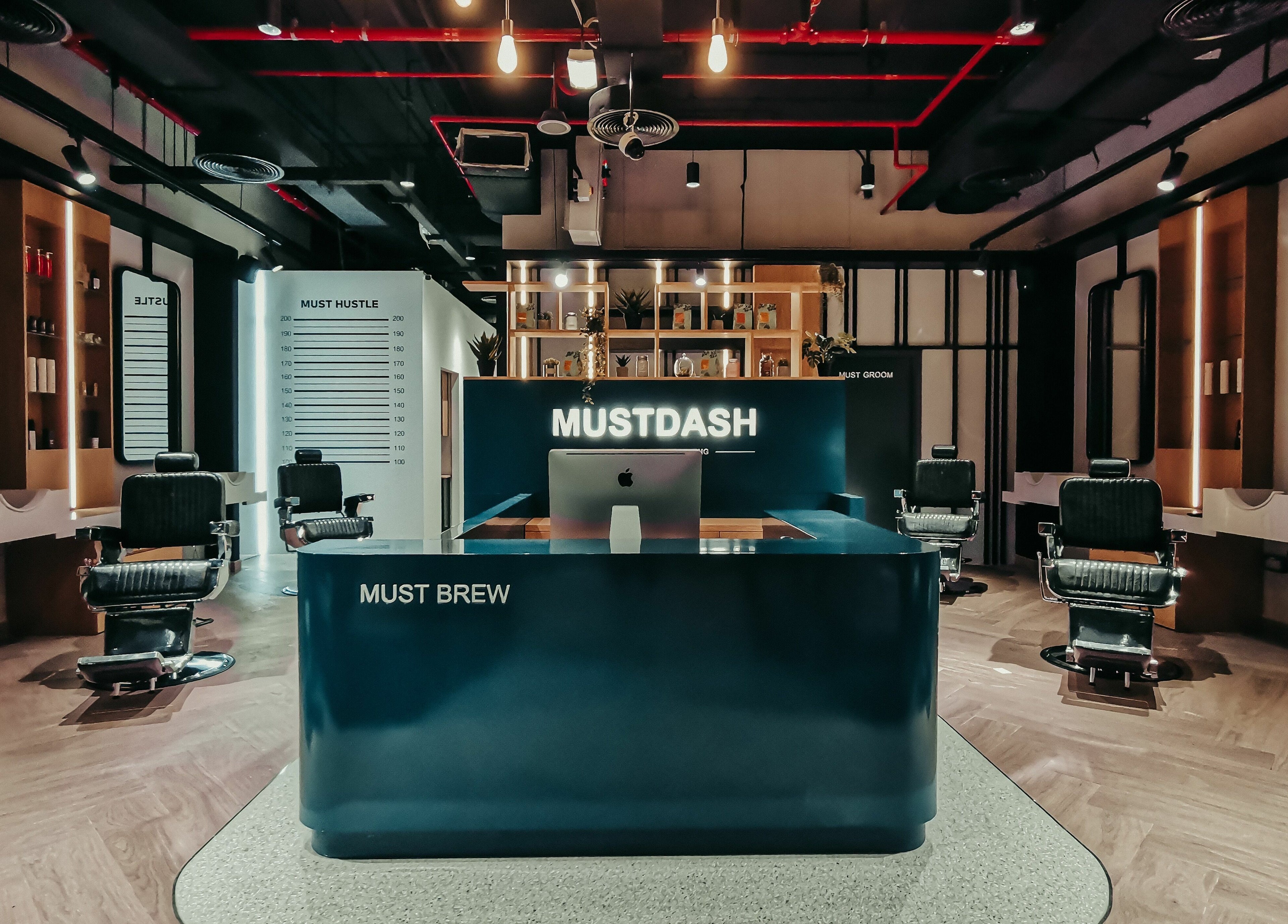 Luxurious interior of Must Dash - Bespoke Men’s Grooming in Dubai, AE, showcasing modern styling chairs.