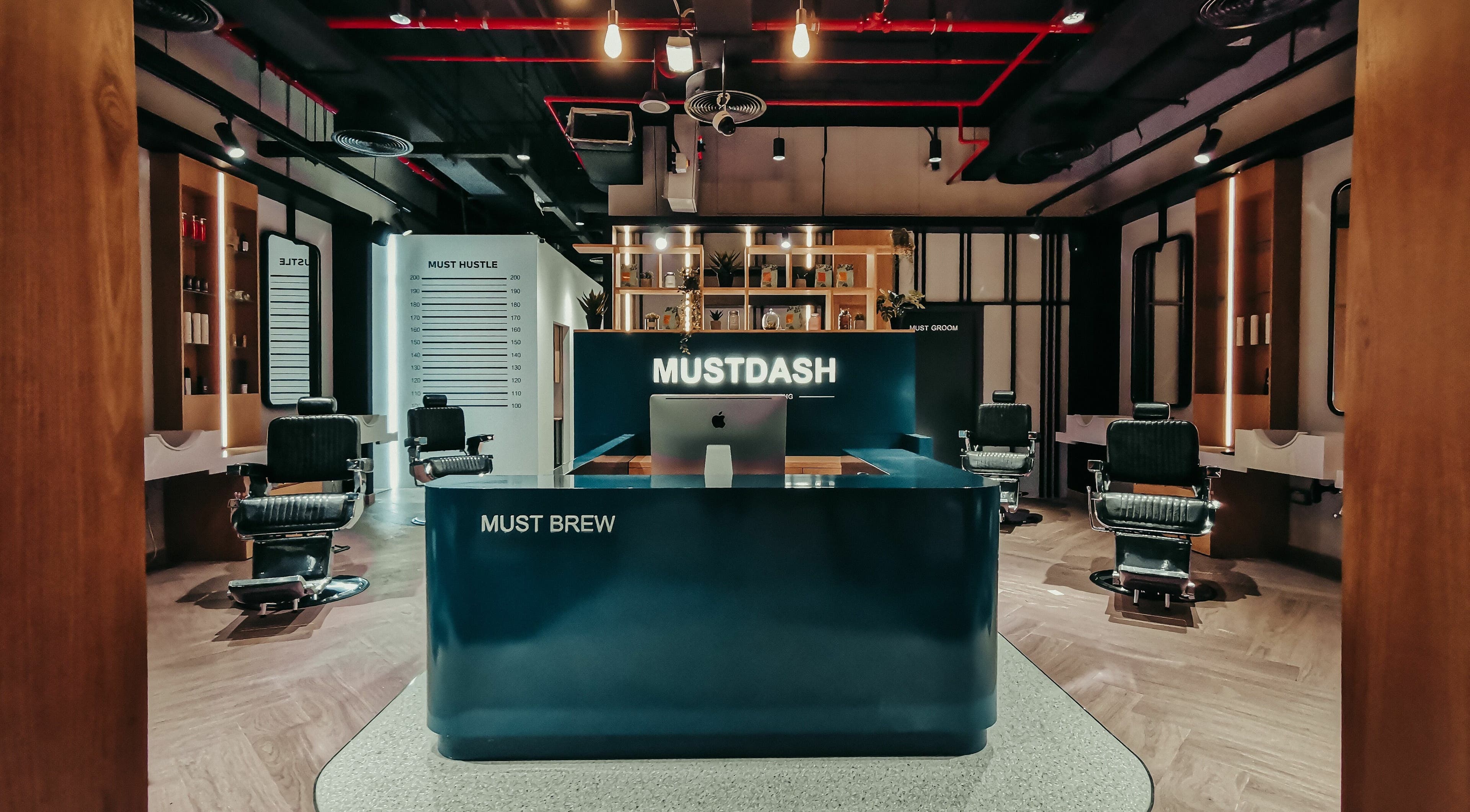 Luxurious interior of Must Dash - Bespoke Men’s Grooming in Dubai, AE, showcasing modern styling chairs.