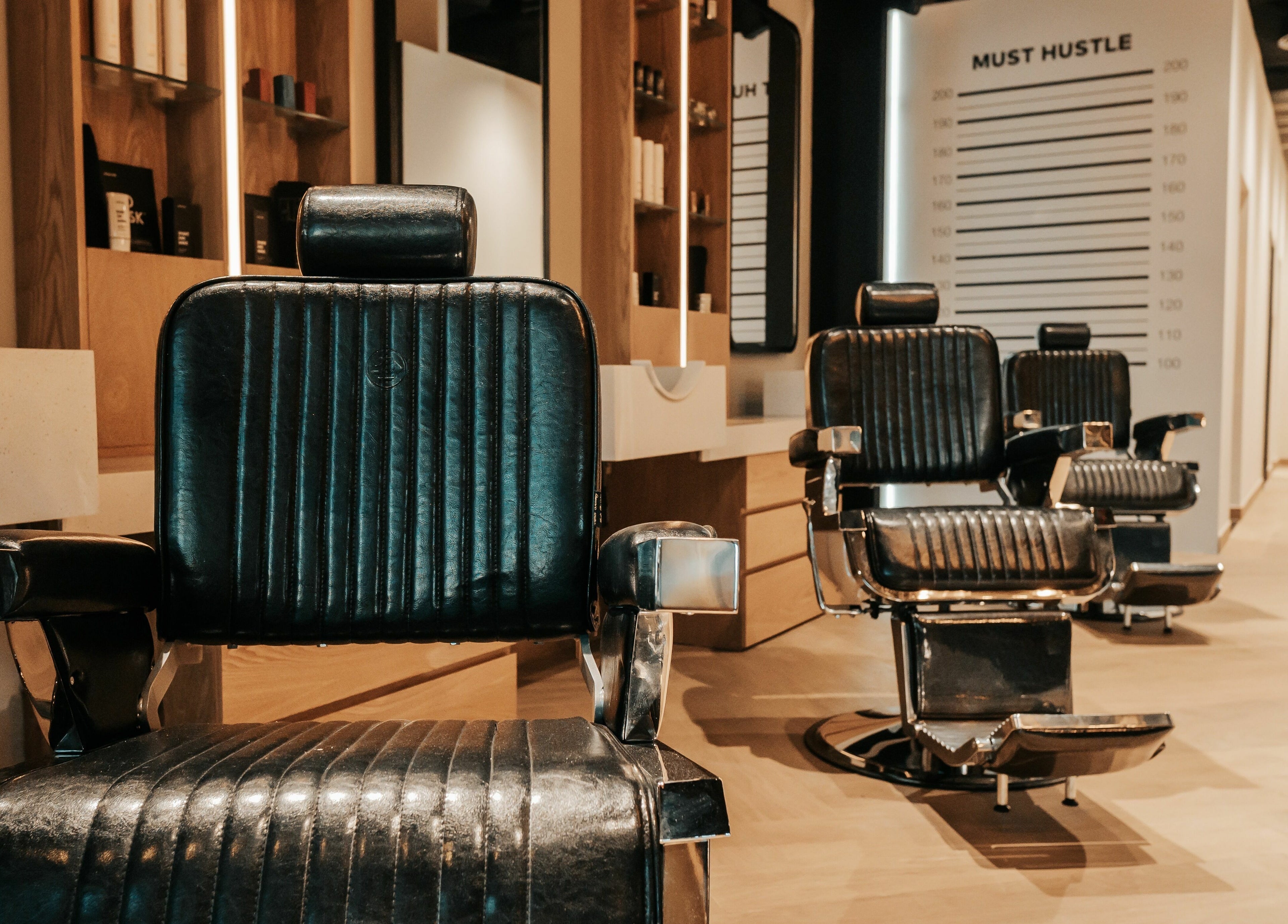 Elegant barber chairs at Must Dash - Bespoke Men’s Grooming in Dubai, AE, showcasing luxury grooming.