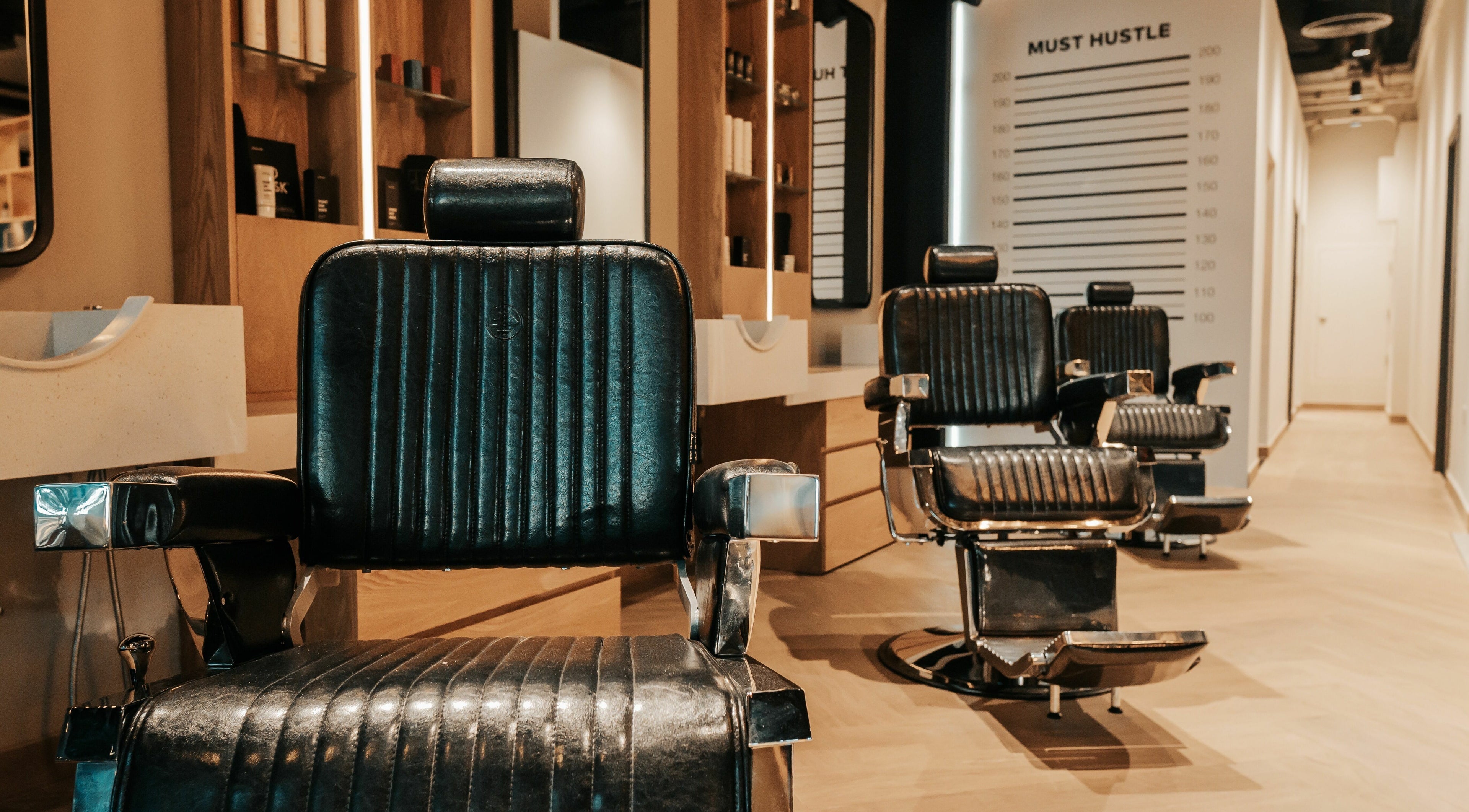 Elegant barber chairs at Must Dash - Bespoke Men’s Grooming in Dubai, AE, showcasing luxury grooming.