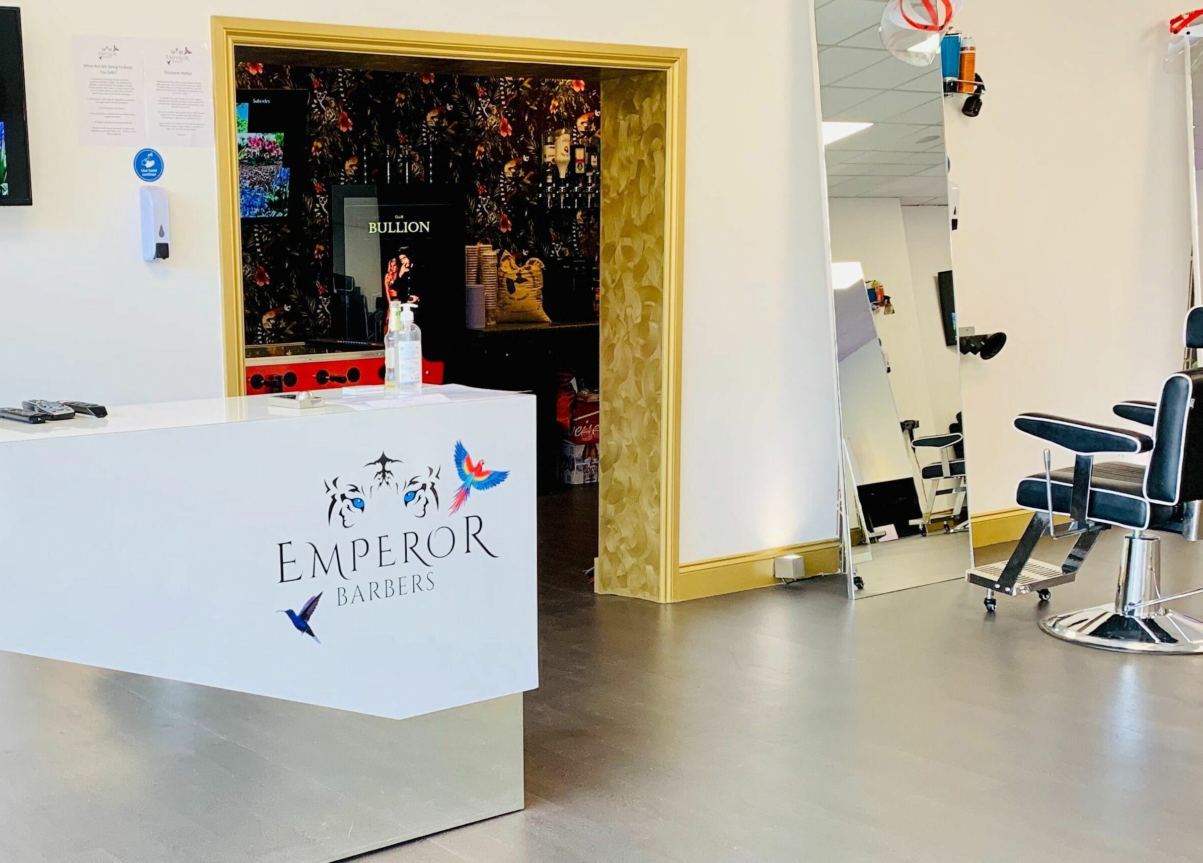 Modern interior of Emperor Barbers, Dunstable, England, GB with sleek chairs and minimalist decor.