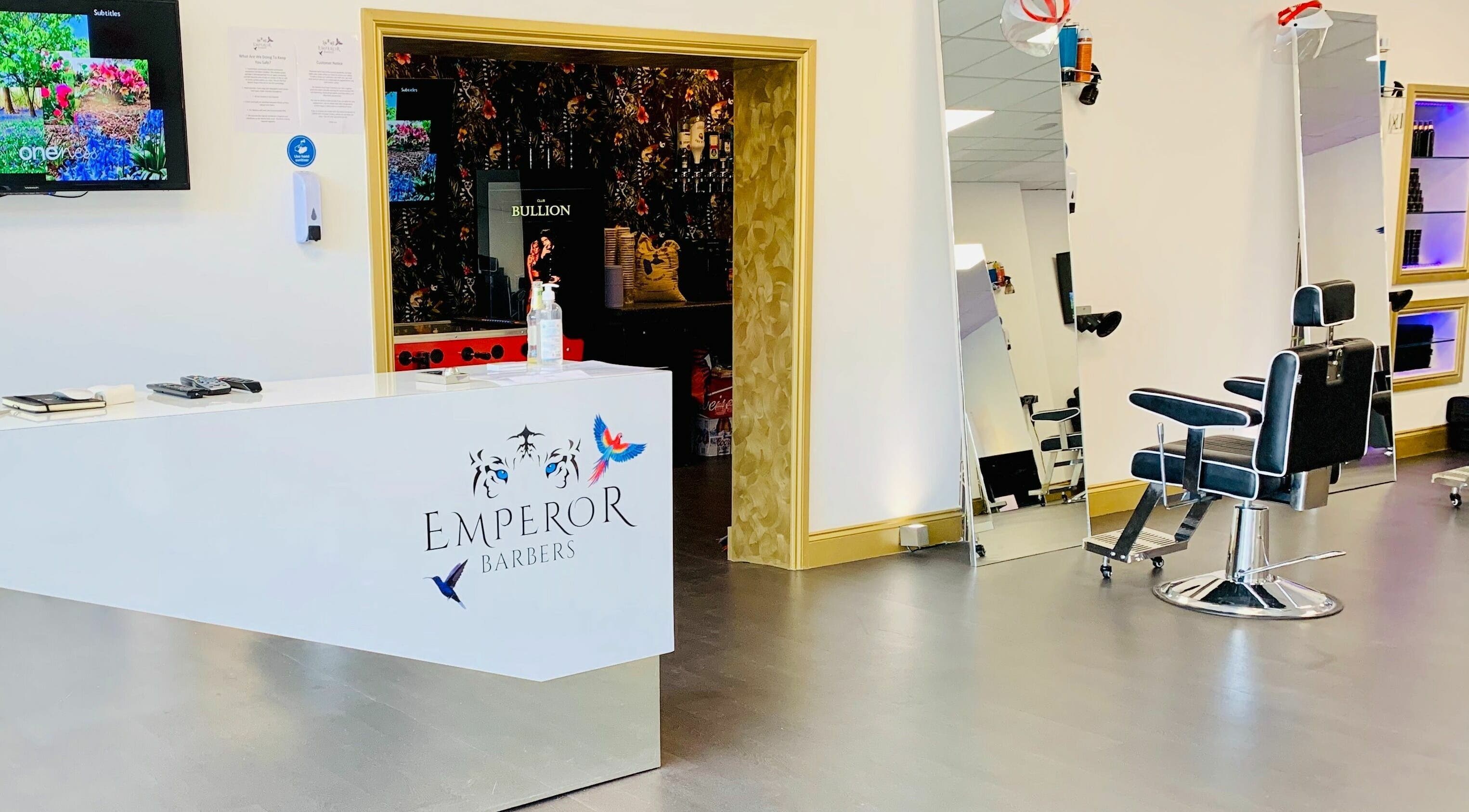 Modern interior of Emperor Barbers, Dunstable, England, GB with sleek chairs and minimalist decor.