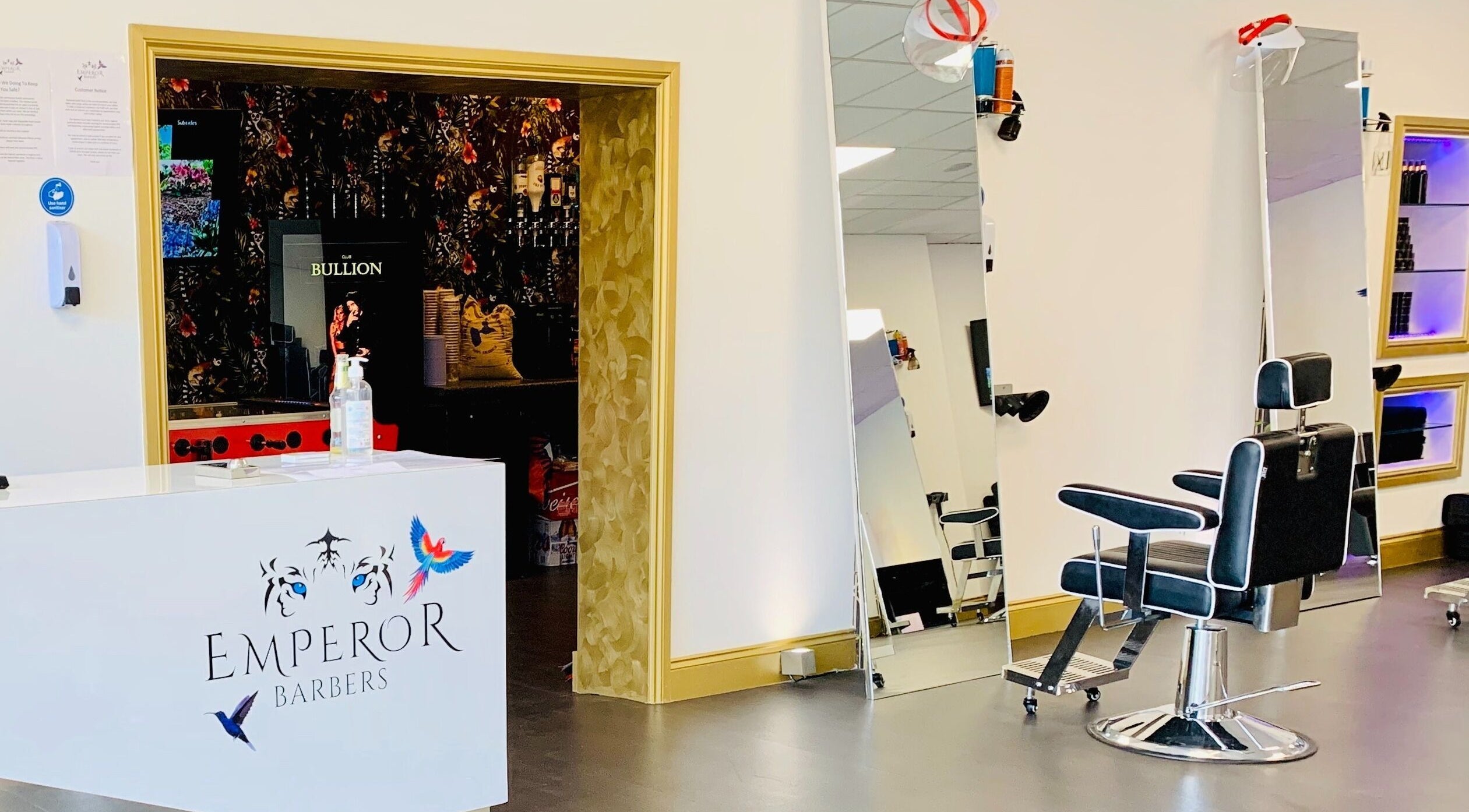 Interior of Emperor Barbers in Dunstable, England, showcasing modern barber chair and sleek decor.