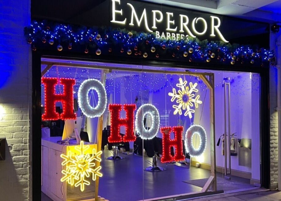 Festive holiday lights with 'Ho Ho Ho' at Emperor Barbers, Dunstable, England, GB.