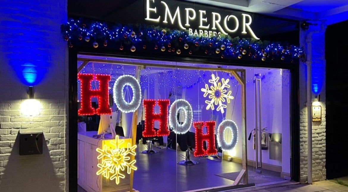 Festive holiday lights with 'Ho Ho Ho' at Emperor Barbers, Dunstable, England, GB.