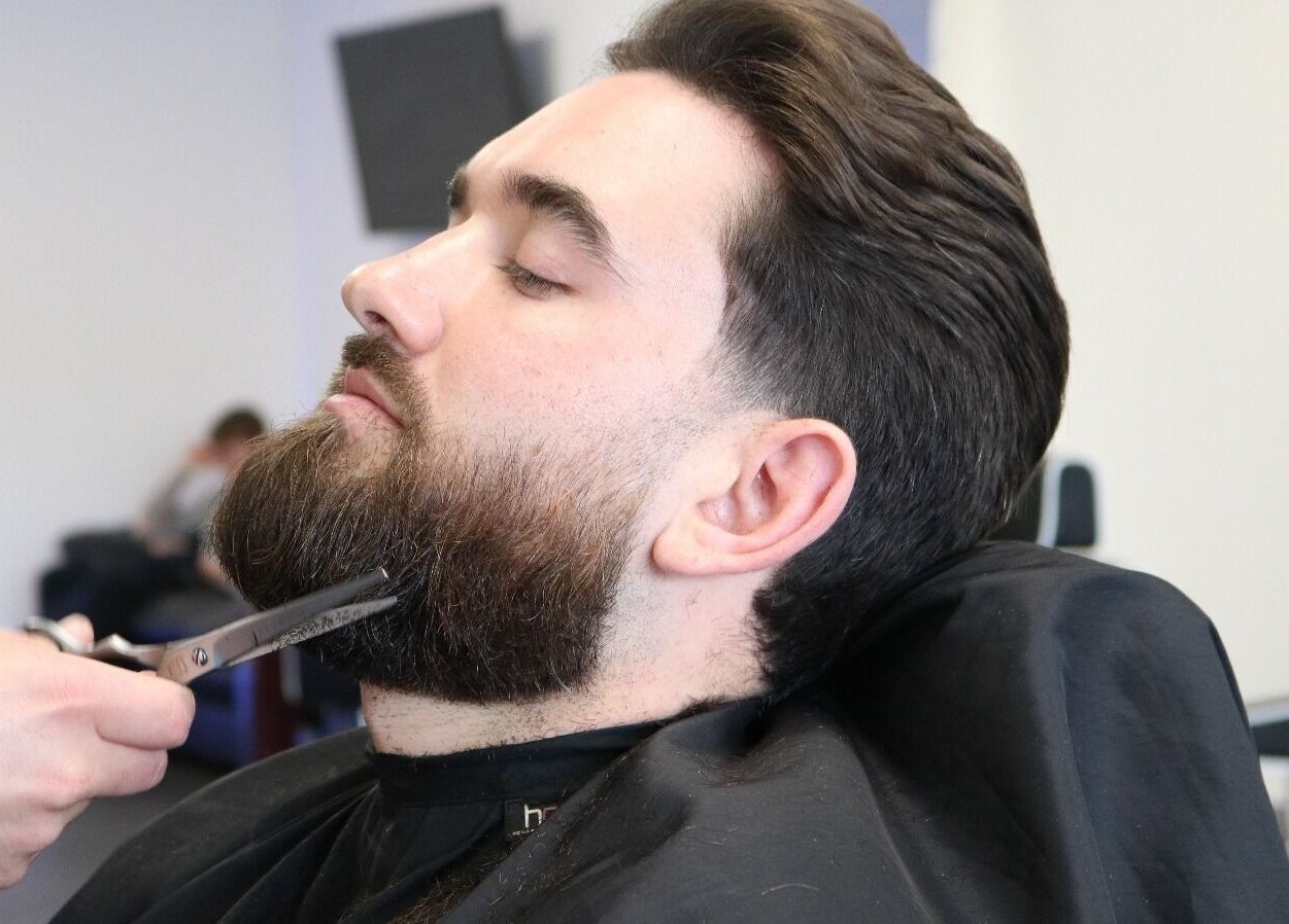 Beard grooming service at Emperor Barbers, Dunstable, England, GB, showcasing expert scissor skills.