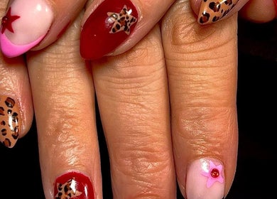 Stylish nail art at The Luxury Nail Bar, Tweedbank, Scotland, GB, featuring leopard and star designs.