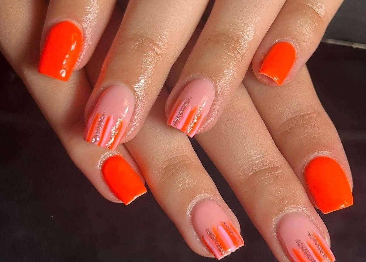 Bright nail art at The Luxury Nail Bar in Galashiels, Scotland, GB showcasing orange and pink designs.