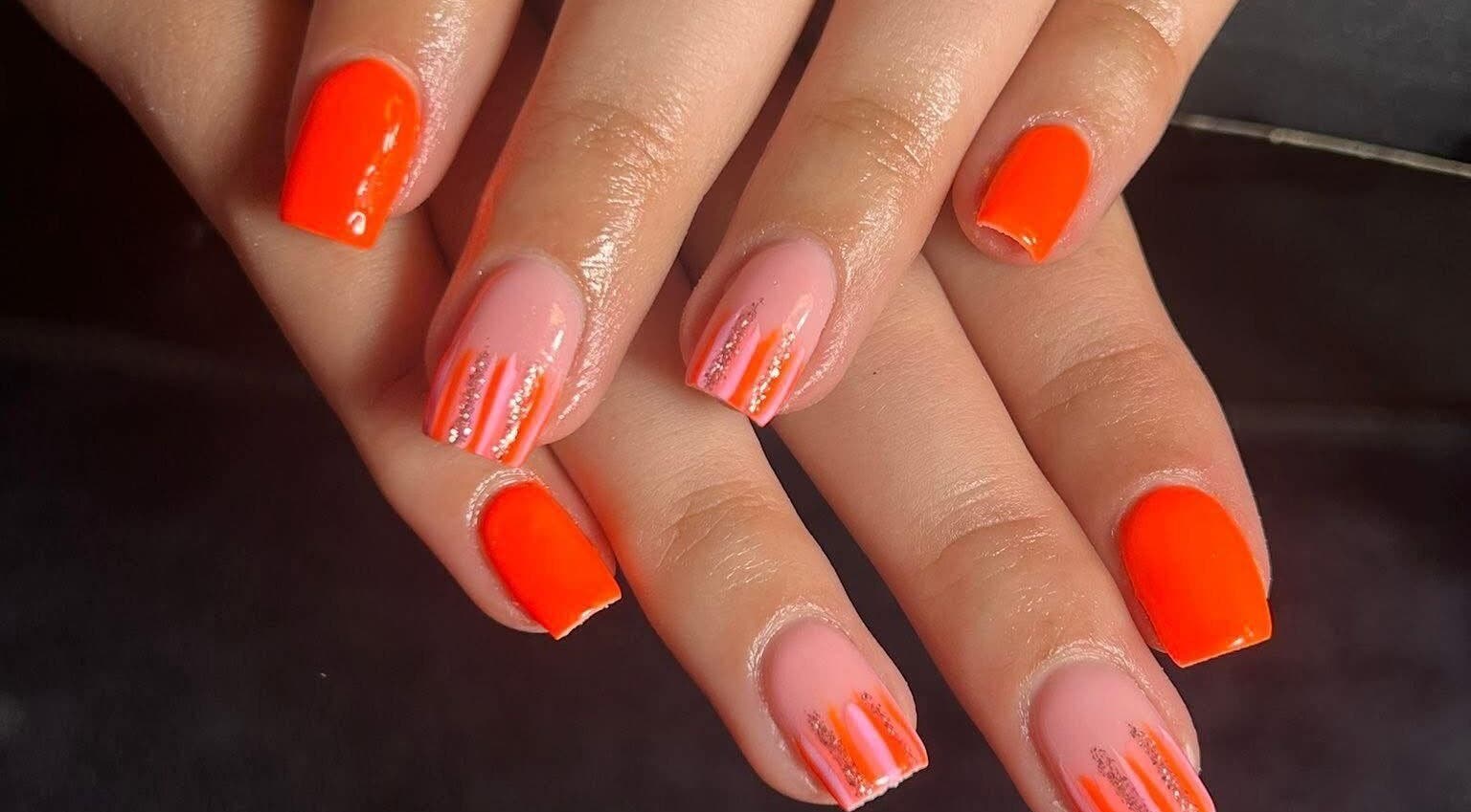 Bright nail art at The Luxury Nail Bar in Galashiels, Scotland, GB showcasing orange and pink designs.