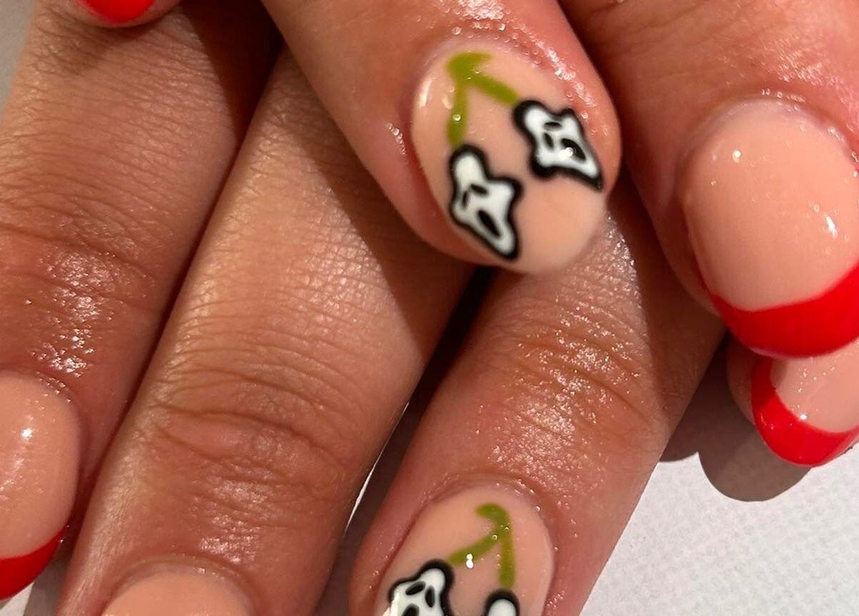 Elegant floral nail art with red tips at The Luxury Nail Bar, Galashiels, Scotland, GB.