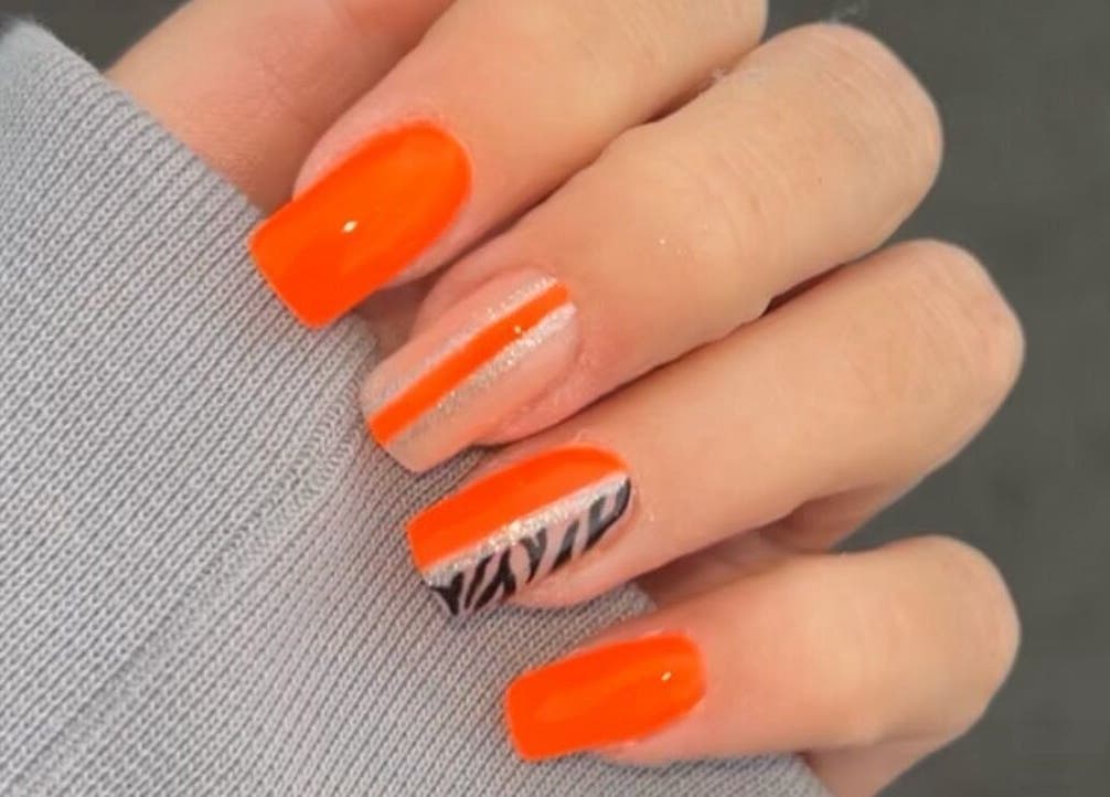 Stylish orange nail art at The Luxury Nail Bar, Galashiels, Scotland, GB, featuring trendy designs.