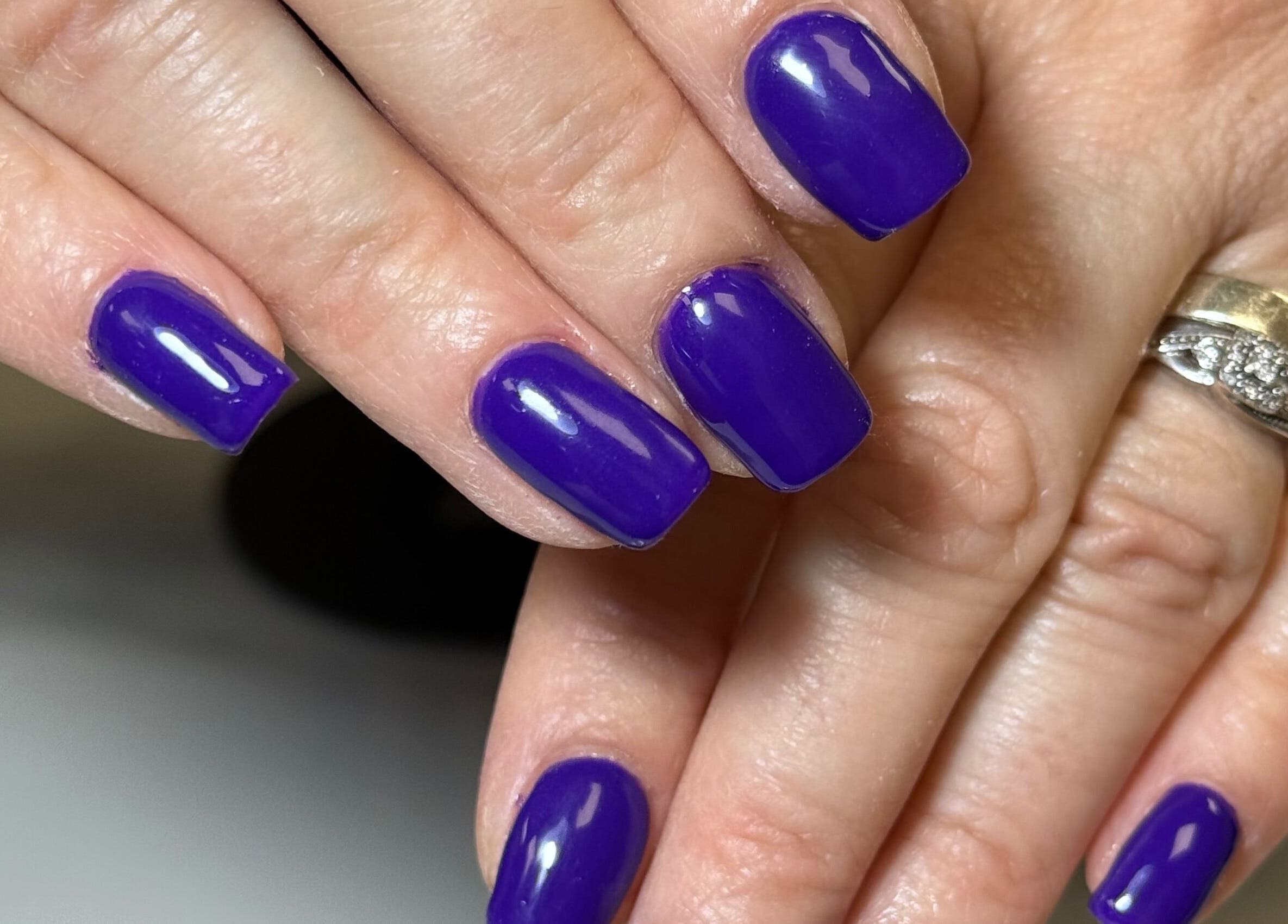 Vibrant purple manicure at The Luxury Nail Bar, Galashiels, Scotland, GB, showcasing salon artistry.
