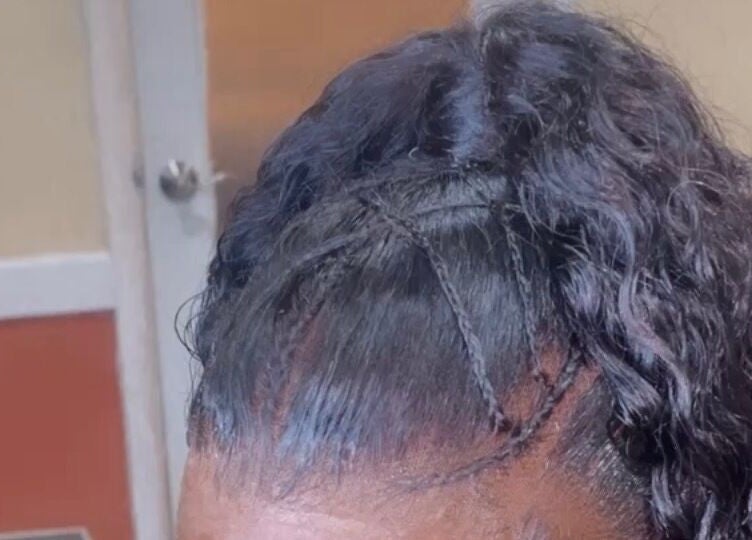 Stylish braided updo at Dvah’s Luxe Beauty & Esthetics in Nassau, New Providence, BS.