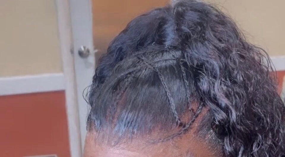 Stylish braided updo at Dvah’s Luxe Beauty & Esthetics in Nassau, New Providence, BS.