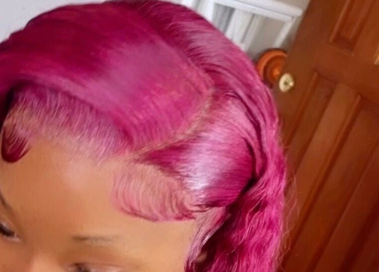 Vibrant pink hairstyle showcased at Dvah’s Luxe Beauty & Esthetics, Nassau, New Providence, BS.