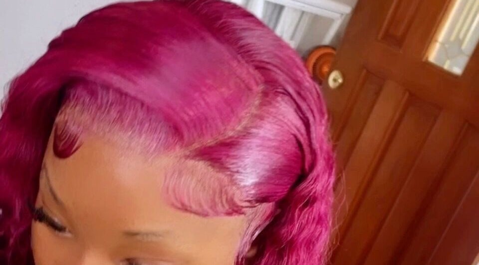 Vibrant pink hairstyle showcased at Dvah’s Luxe Beauty & Esthetics, Nassau, New Providence, BS.