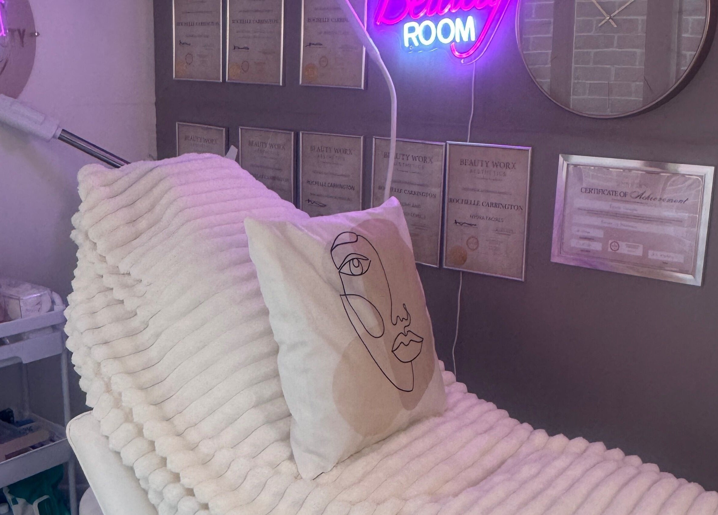 Cozy treatment room at Aesthetics & Beauty By Rochelle, Croydon, England, GB, with soft lighting and certificates.