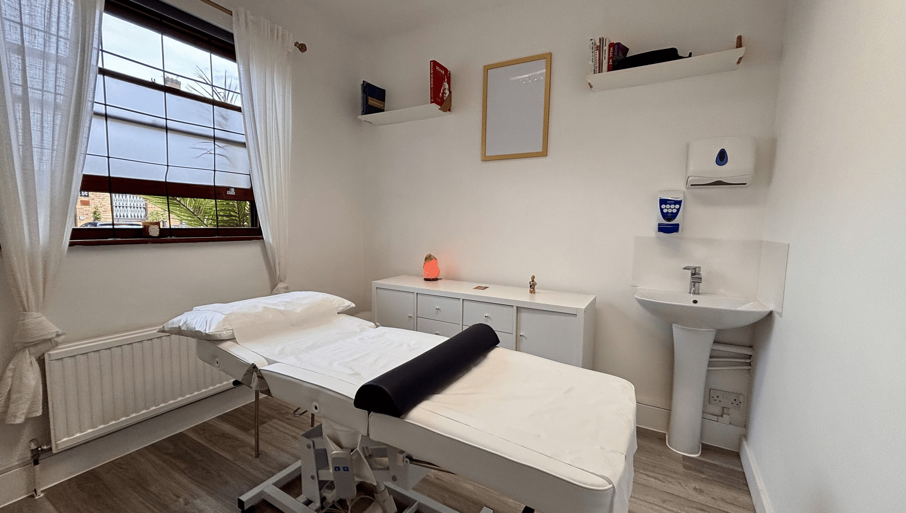 A calming treatment room at Osteotherapy Lab, London, England, GB, featuring a massage table and ambient lighting.