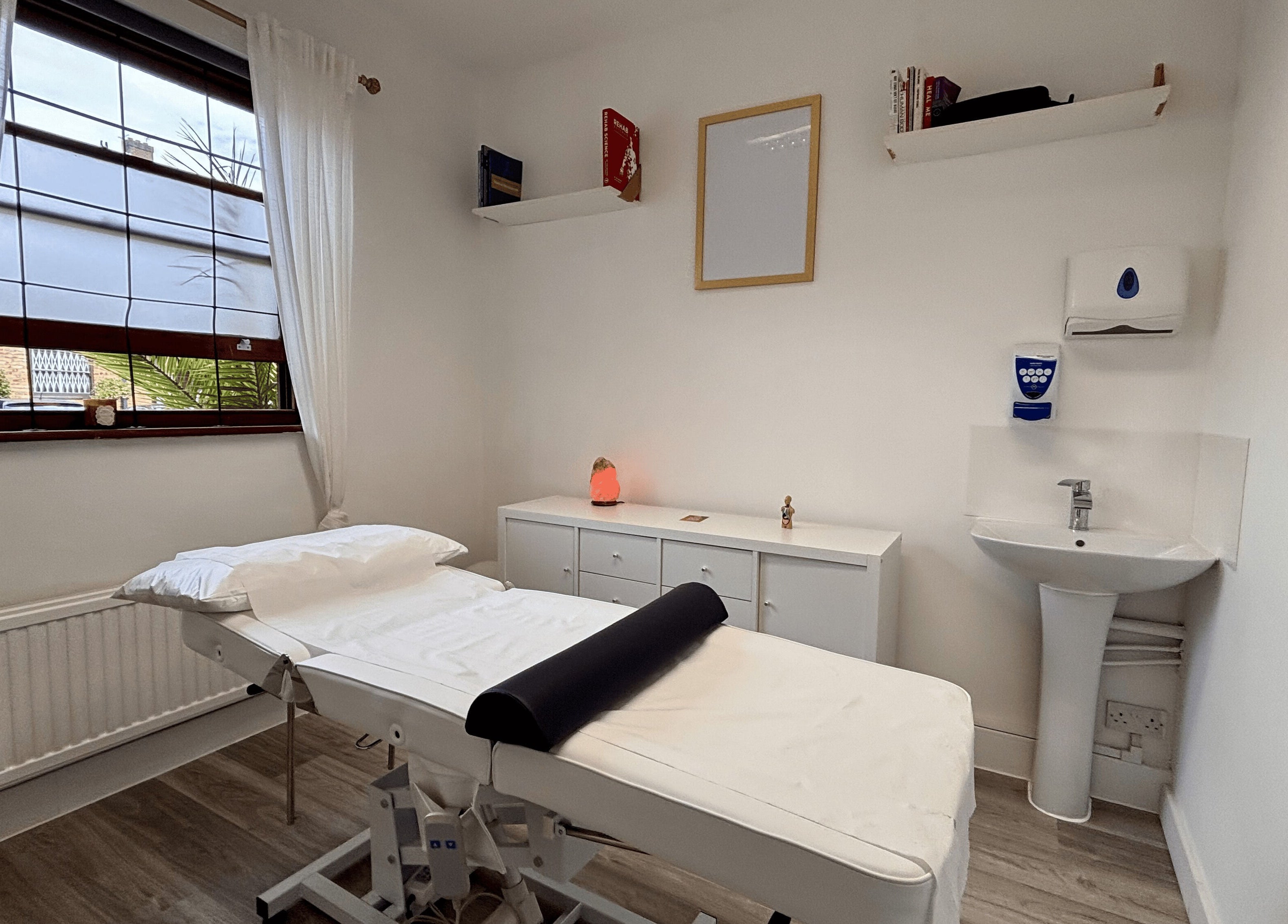 A calming treatment room at Osteotherapy Lab, London, England, GB, featuring a massage table and ambient lighting.