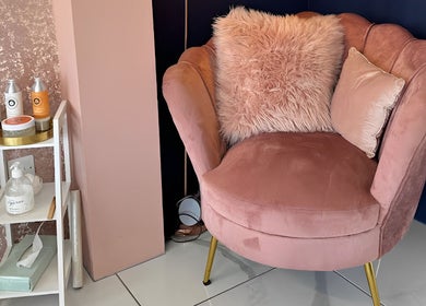 Cozy pink chair with fluffy cushions at GHB Beauty, Great Wyrley, England, enhancing relaxation ambiance.