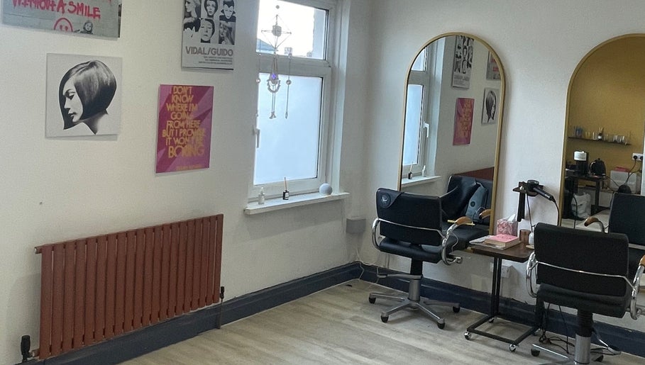 Modern salon interior at Studio B, Cardiff, Wales, GB with stylish decor and large mirrors.