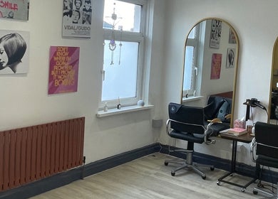 Modern salon interior at Studio B, Cardiff, Wales, GB with stylish decor and large mirrors.