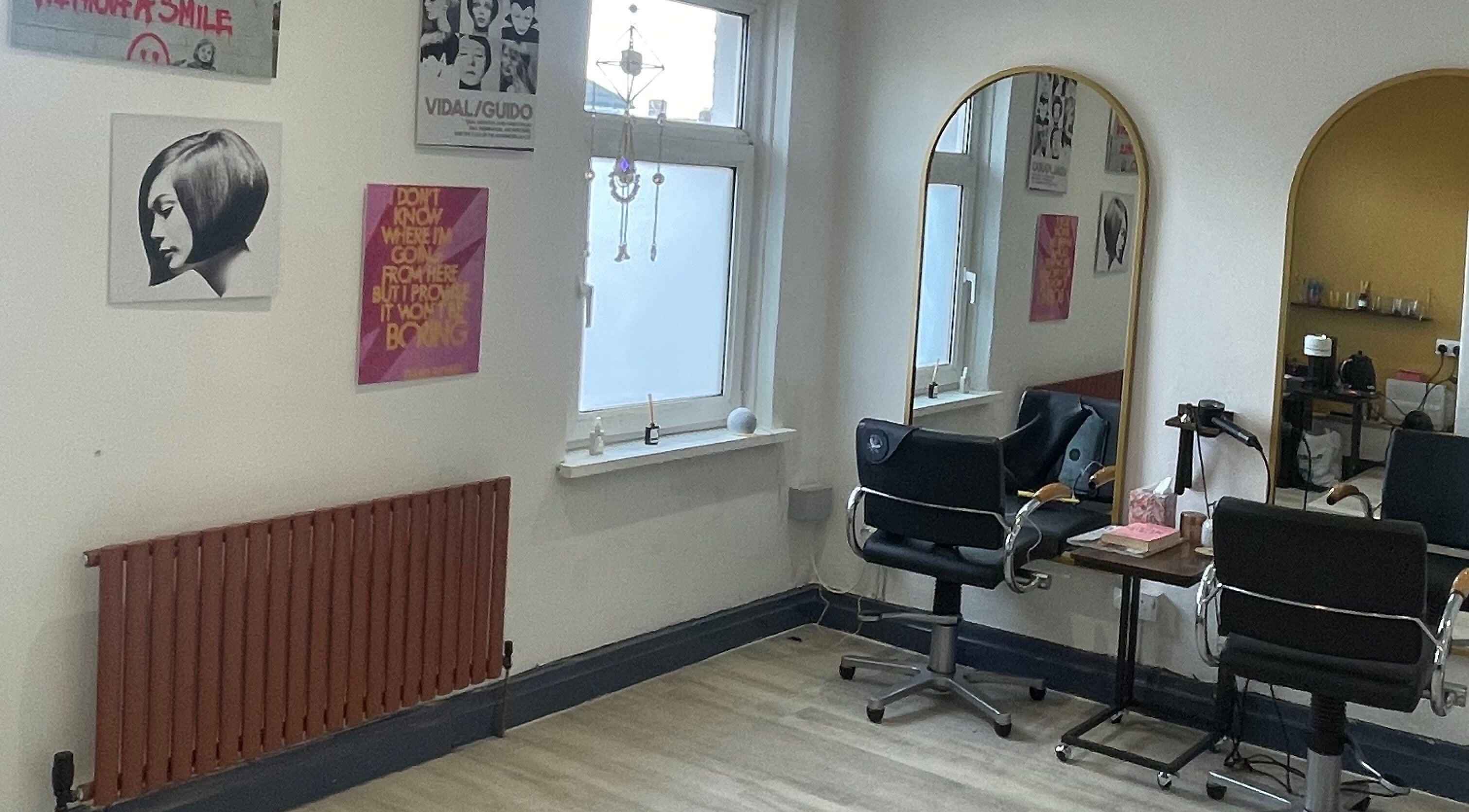 Modern salon interior at Studio B, Cardiff, Wales, GB with stylish decor and large mirrors.