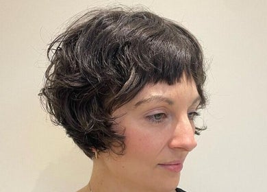 Woman with stylish curly bob haircut at Studio B, Cardiff, Wales, GB.
