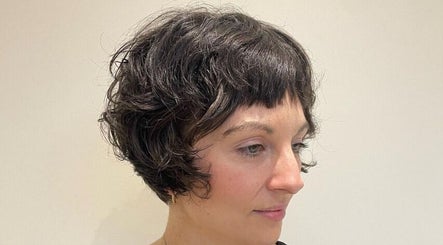 Woman with stylish curly bob haircut at Studio B, Cardiff, Wales, GB.