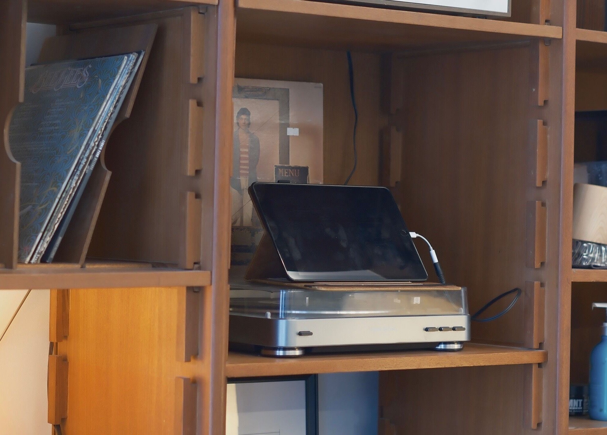 Wooden shelves at cafune. west with a vintage record player, Vancouver, British Columbia, CA.