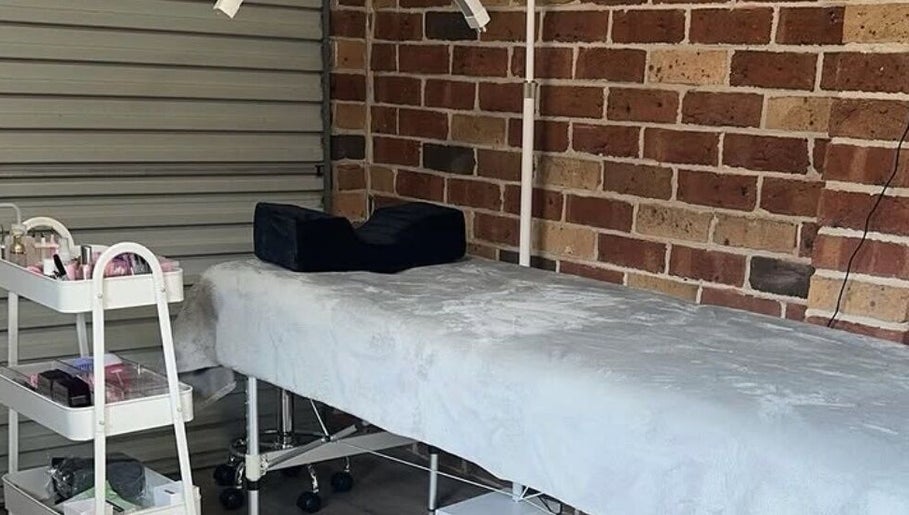Relaxing lash studio at Lasheddbylexy, Elderslie, New South Wales, AU, featuring a treatment bed and beauty cart.