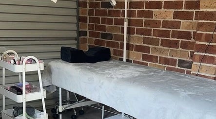Relaxing lash studio at Lasheddbylexy, Elderslie, New South Wales, AU, featuring a treatment bed and beauty cart.