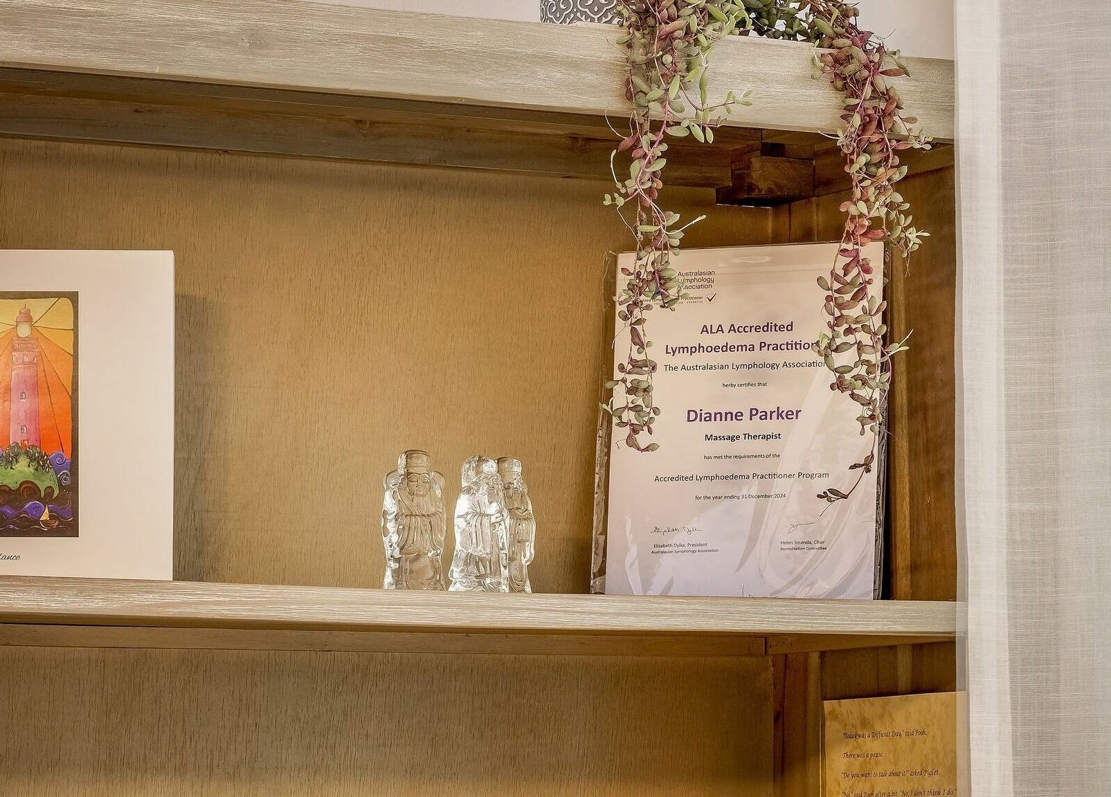 Decorative shelf with certificate and art at Dharma Massage & Movement, Abbey, Western Australia, AU.