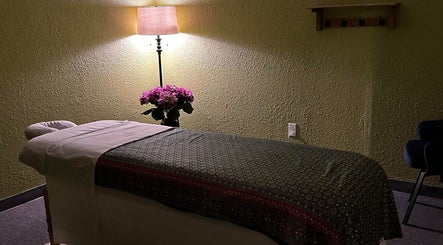 Cozy massage room at Thai Traditional Therapeutic Massage, North Little Rock, Arkansas, US with ambient lighting.