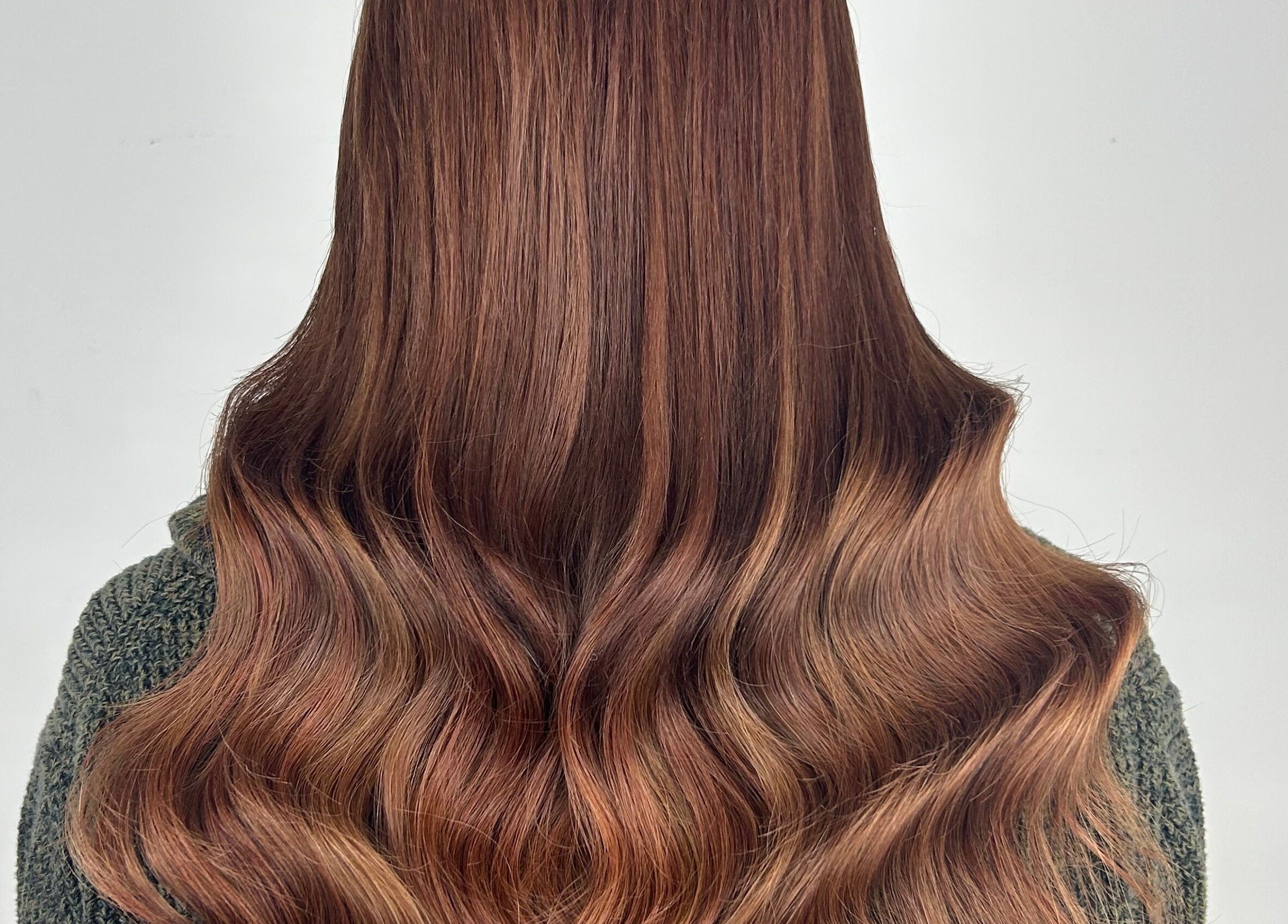 Lustrous auburn hair waves styled at Katie Brady Hair Extensions in Smiths Falls, Ontario, CA.